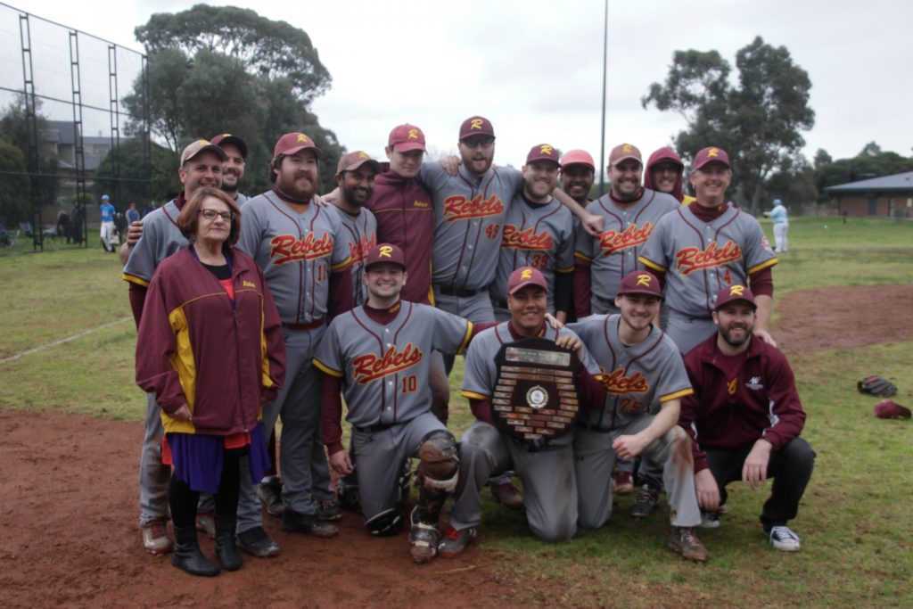 Group of baseball players and officials celebrating a premiership win